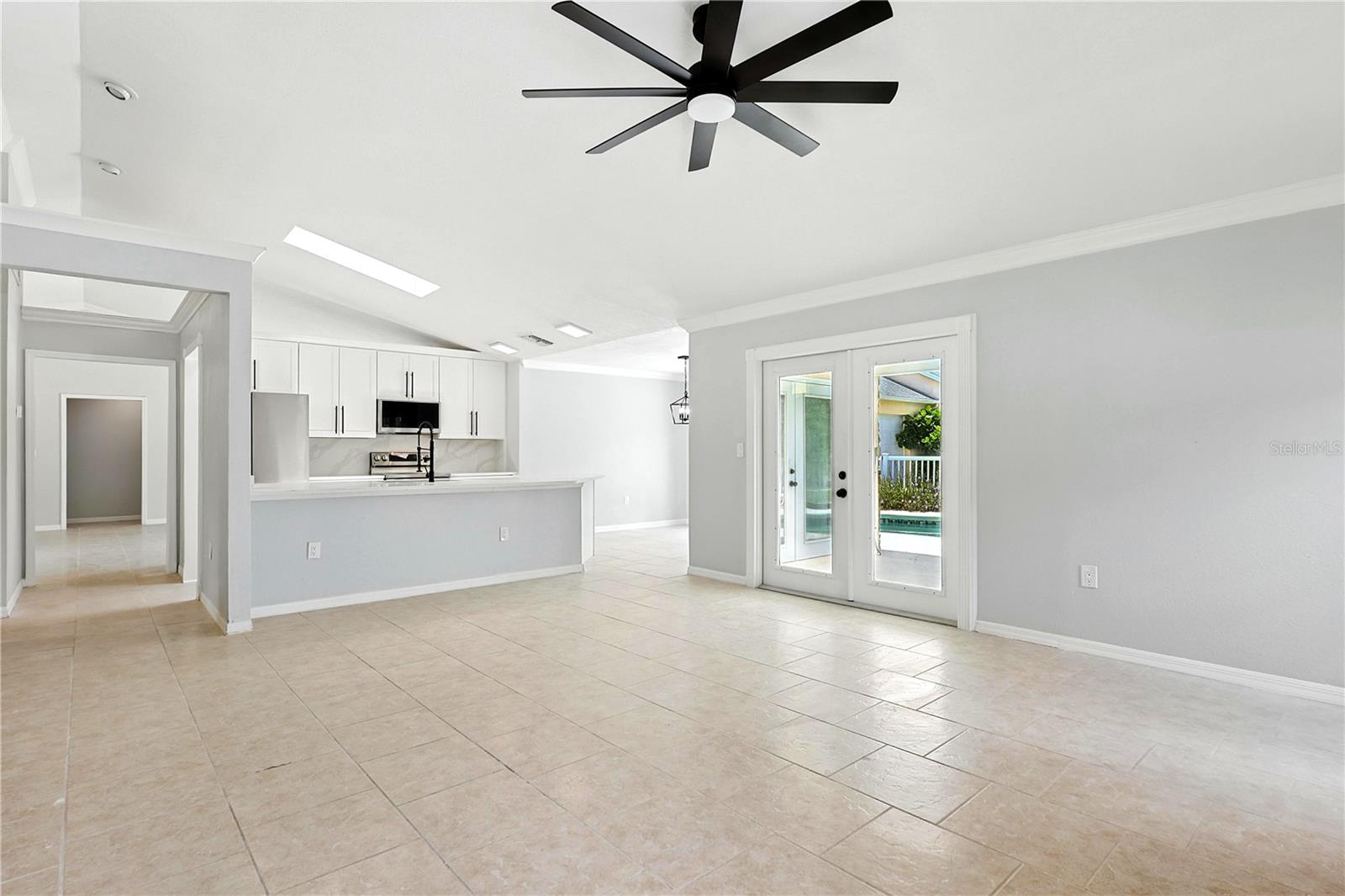 View of kitchen with glass doors leading out to the pool