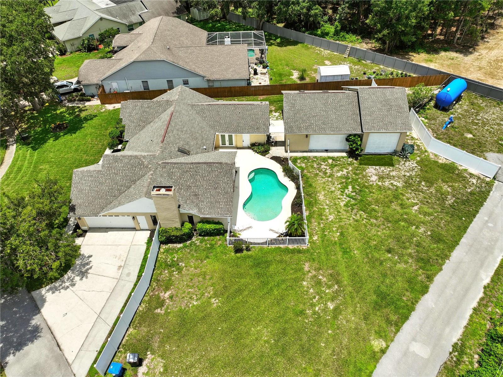 Aerial of properties showing pool and large detached garage