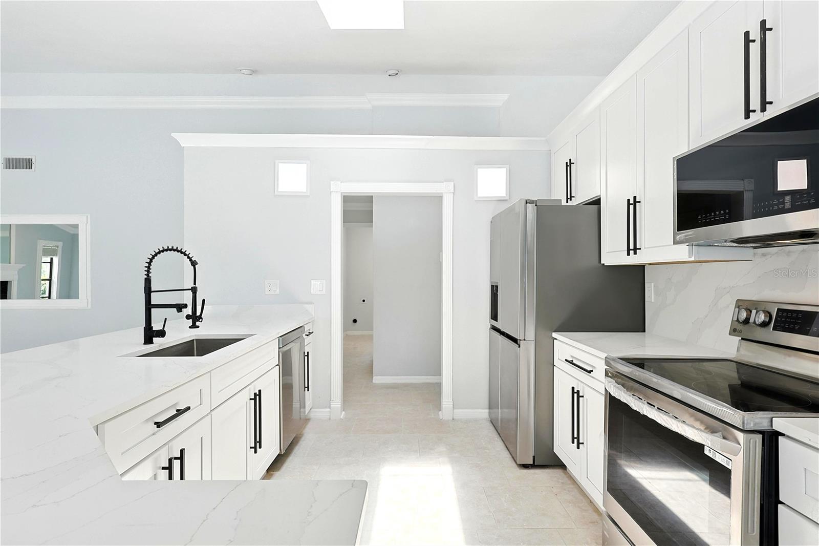 Large kitchen island, quartz countertops with stainless appliances