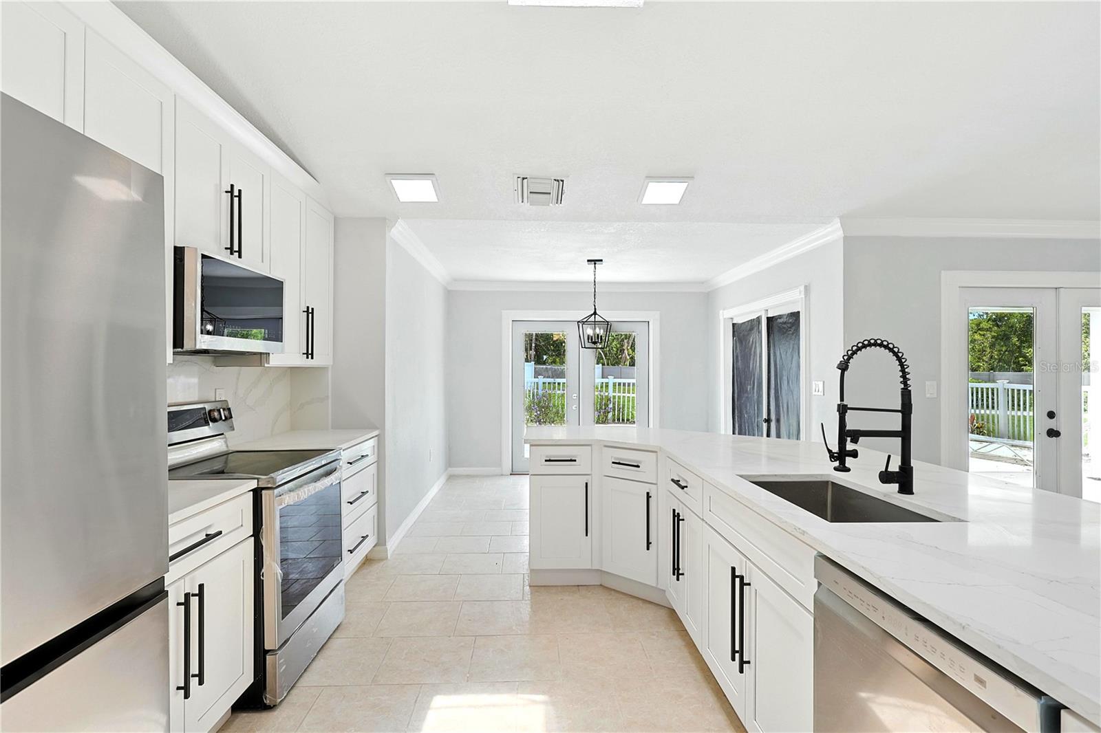 Looking into breakfast area with glass doors that lead out to the pool
