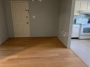 Dining room with door 2nd entrance on left and kitchen on right.