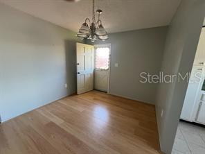 Another view of dining room with exterior door open.
