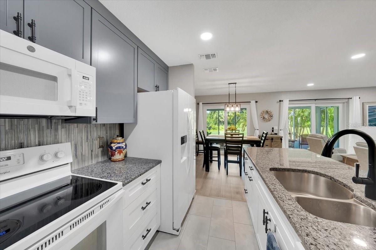 Beautiful glass tiled backsplash tying everything together