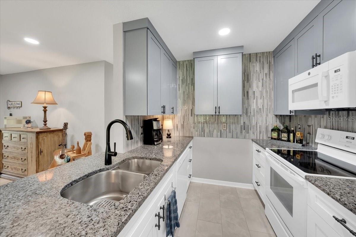 Two tone cabinets with detailed fixtures and finishes