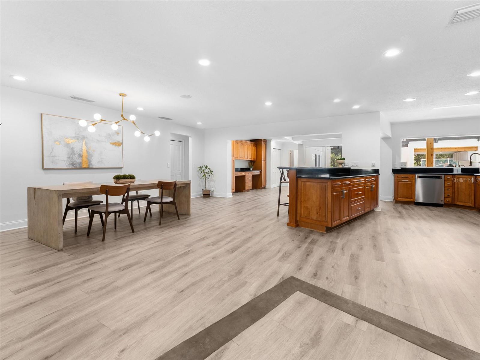 Open concept dining and kitchen with views of the pool