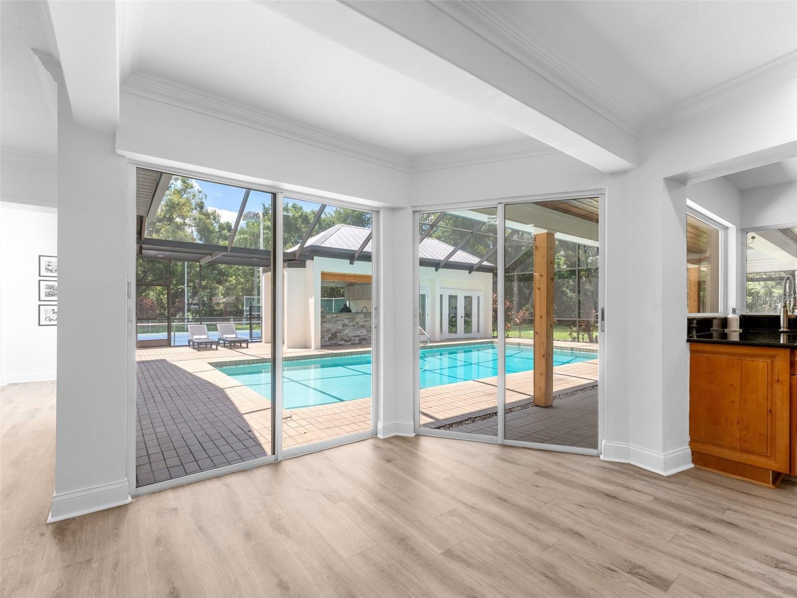 Additional expansive sliders out to the pool and outdoor living areas