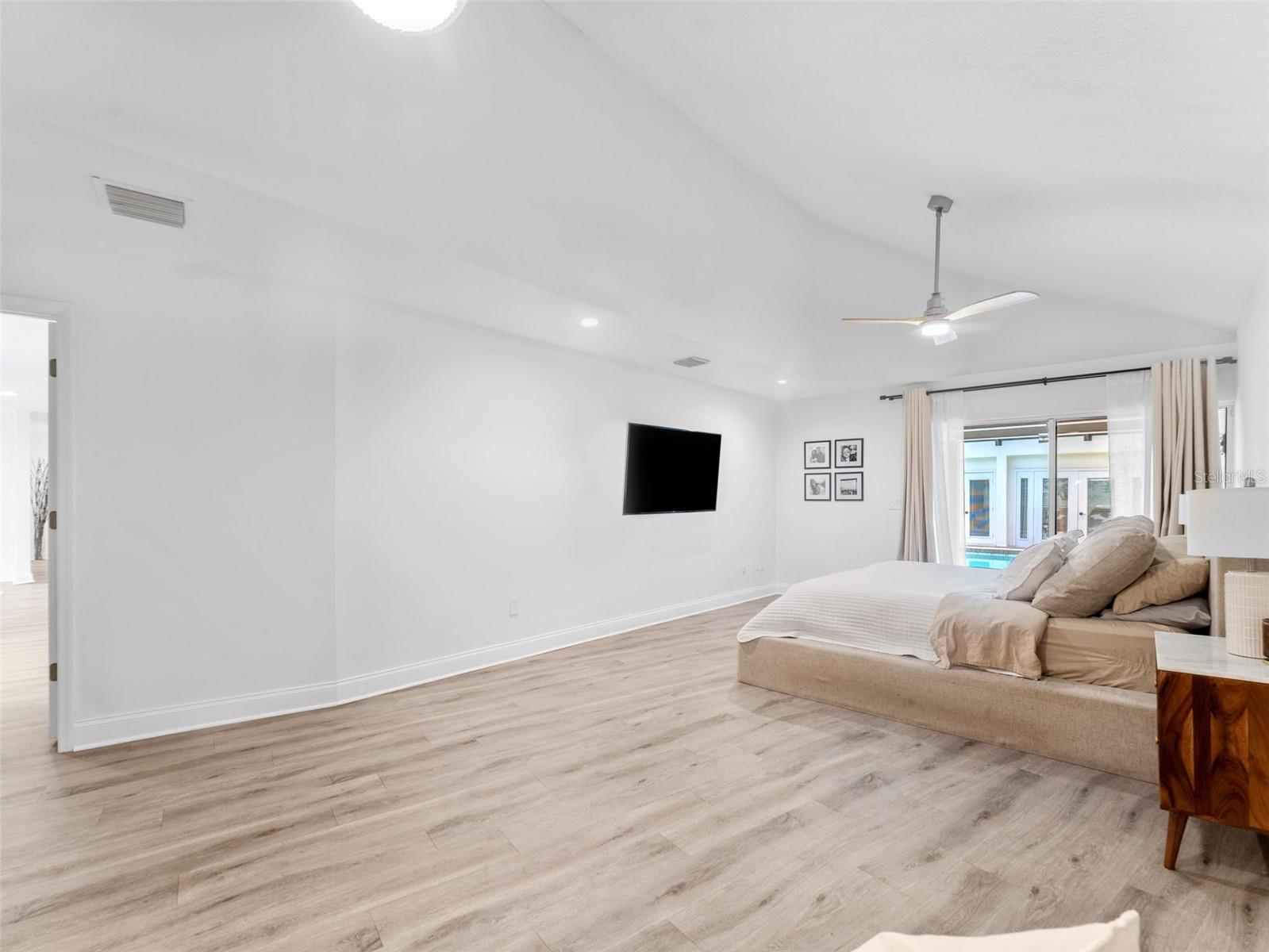 Primary Suite with sliders out to the pool and lounge area