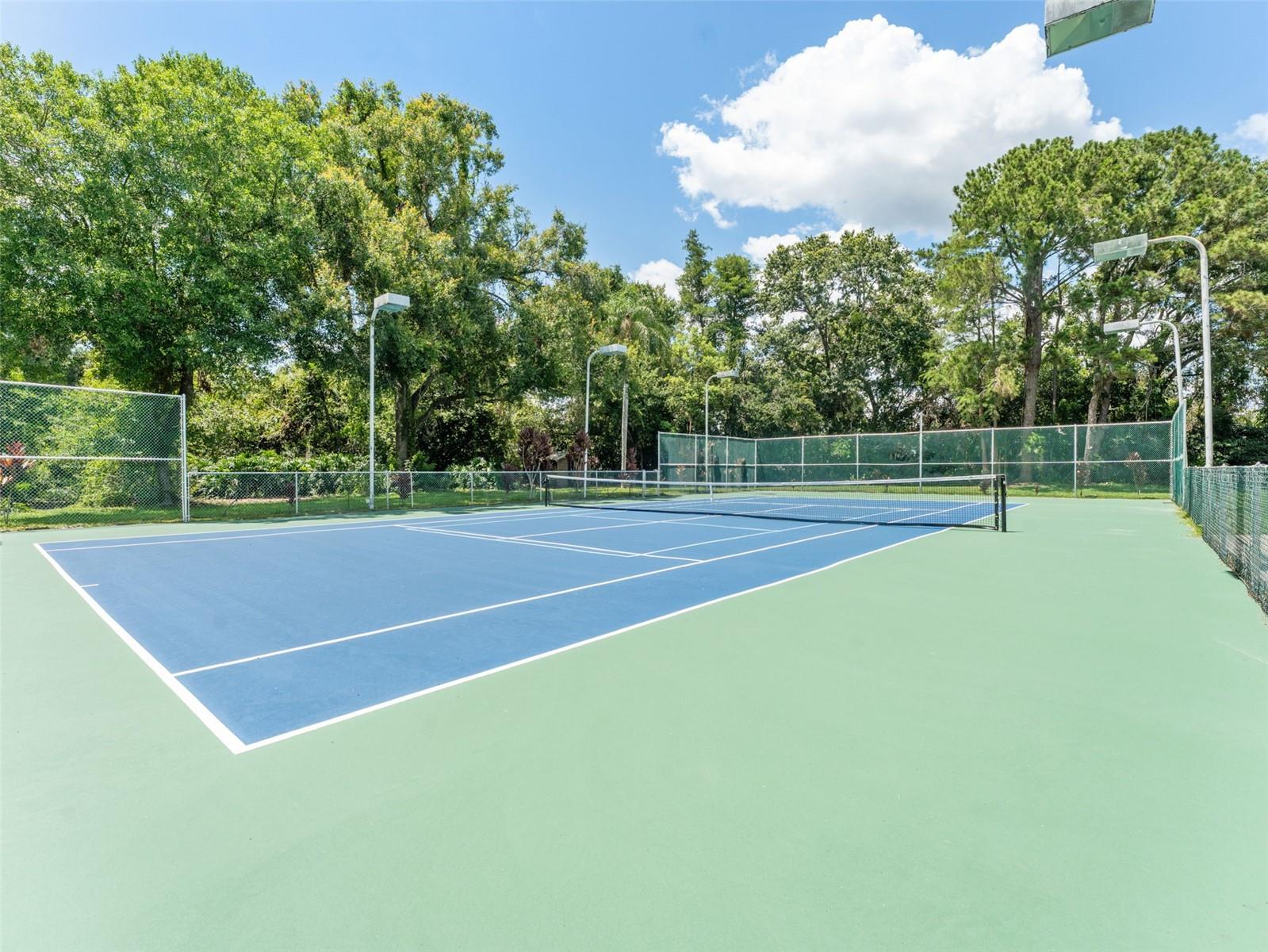 Sunny lounge area, Outdoor Kitchen, and exit to the Courts