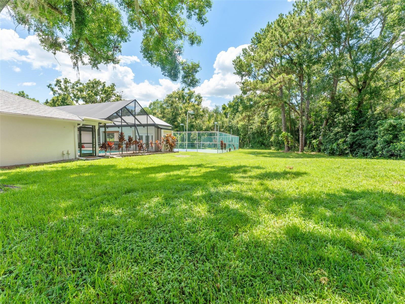 Sweeping lawn bordered by lush Florida greenery.