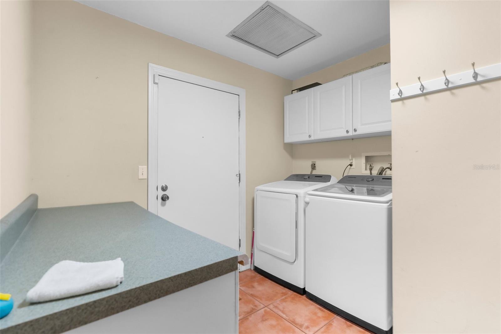 Spacious laundry room with built in storage
