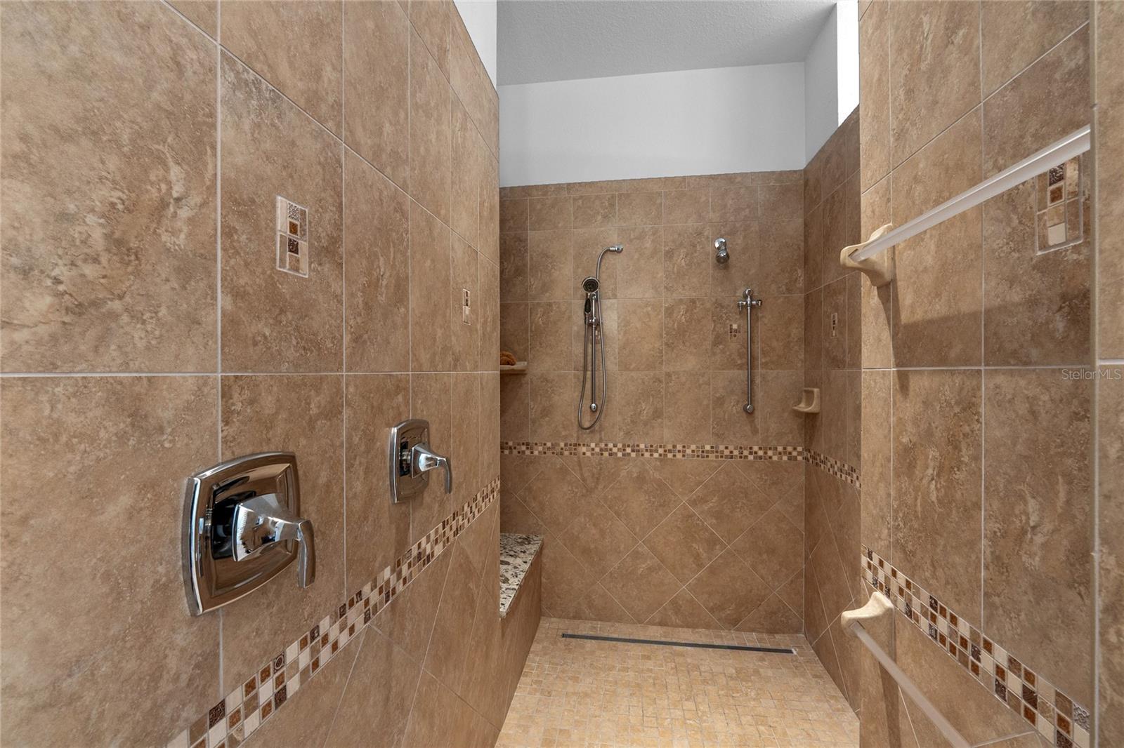 This en suite bathroom has a huge walk in shower