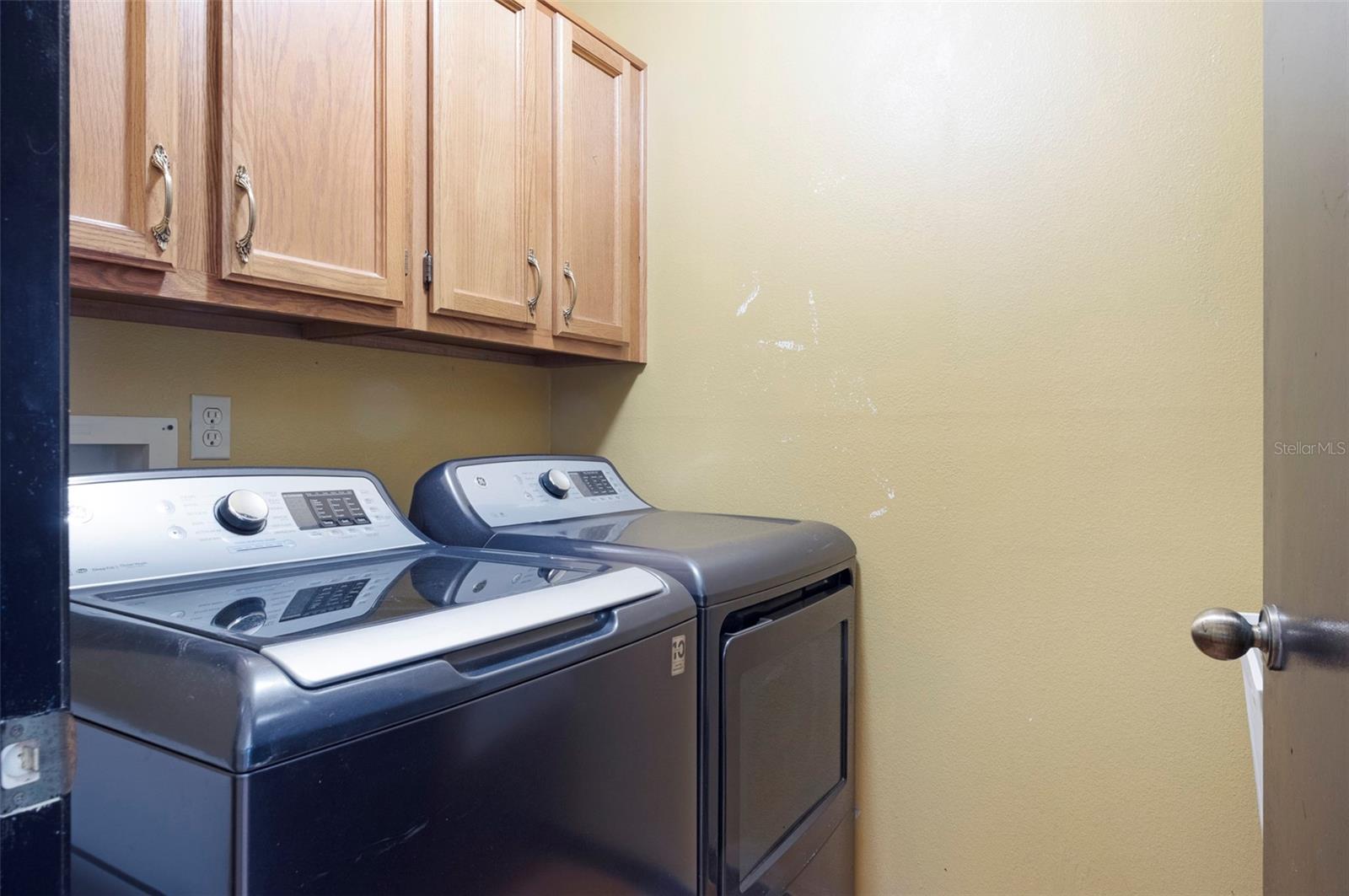 Large Laundry area with sink and closet storage PLUS cabinets.