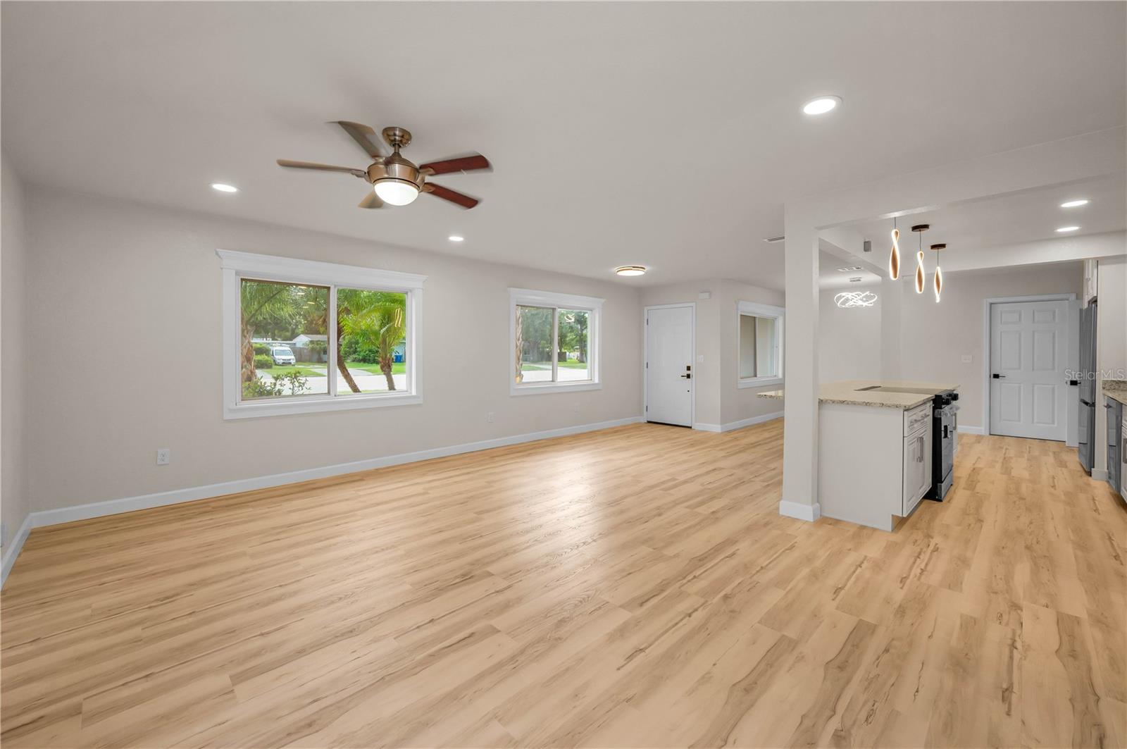 Great room looking back at front door, kitchen and dining