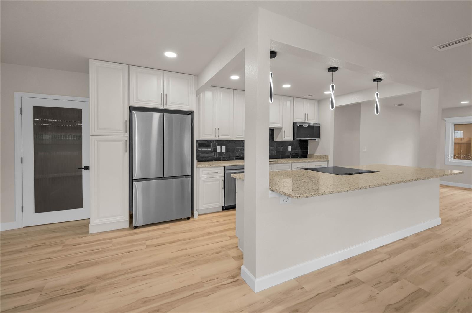 Open kitchen and french door to the left to bonus room
