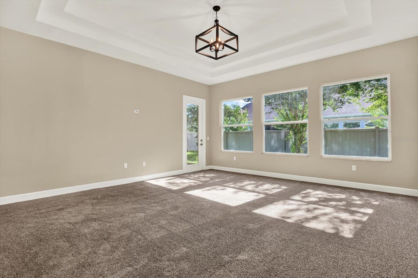 Triple tray ceiling. Door leads to screened lanai.