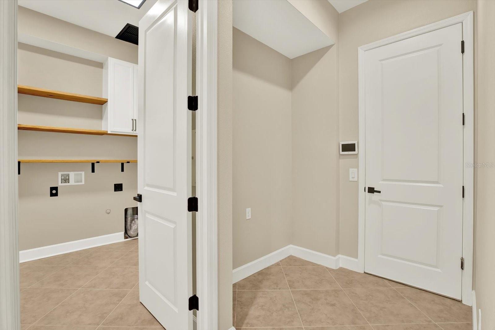 Laundry room on left and door to the 3 car tandem garage on right