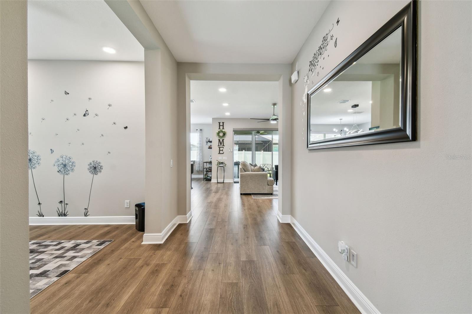 Head down the hall- the open room to the left is used as an office but could be a dining room, playroom or other use! Look at the wide plank floor- a nice touch.