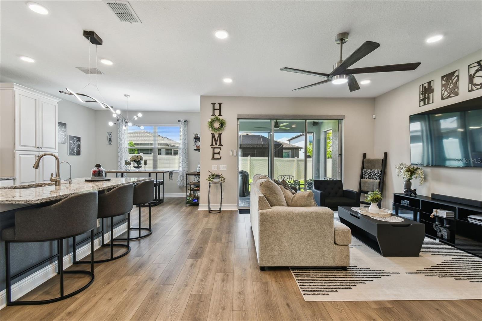 Spacious living space, with room to relax and entertain. Enjoy the triple slider the owners added to make access to outdoors seamless. Designer fans and upgraded lights throughout this home.