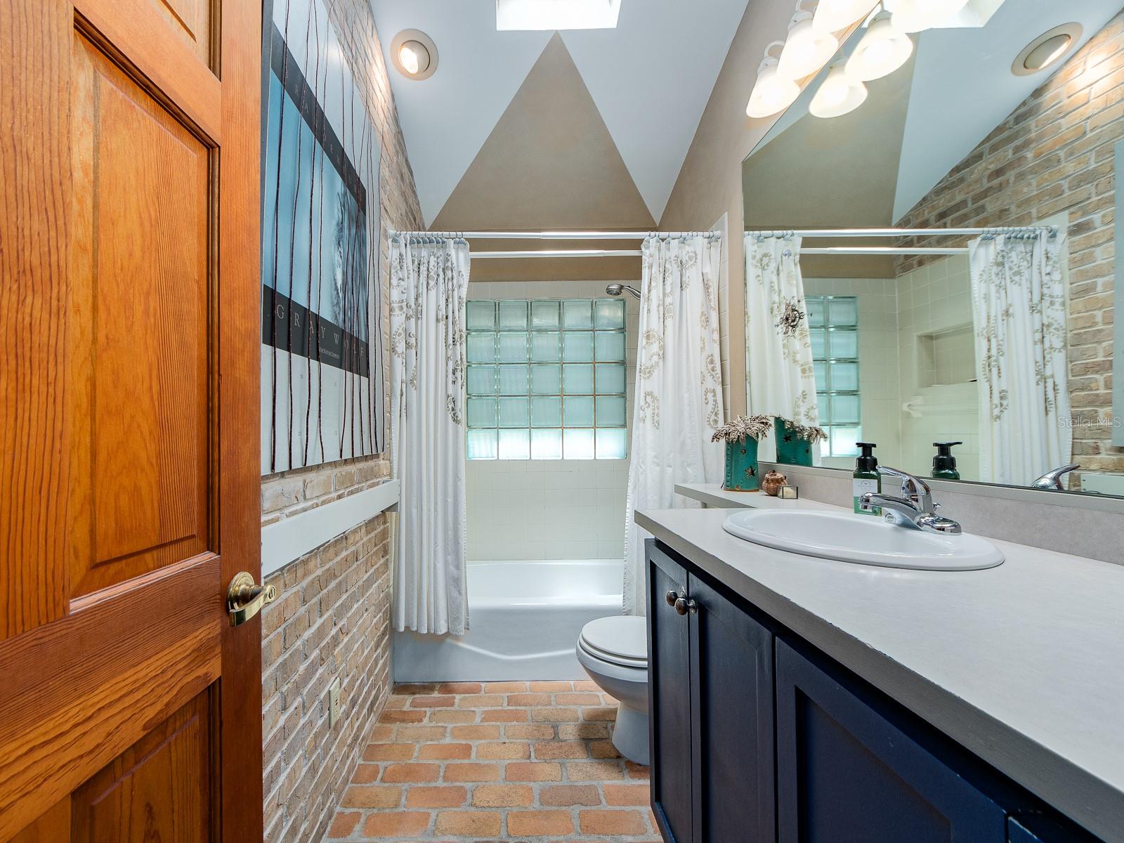 Main House Bathroom with high ceiling and skylight!