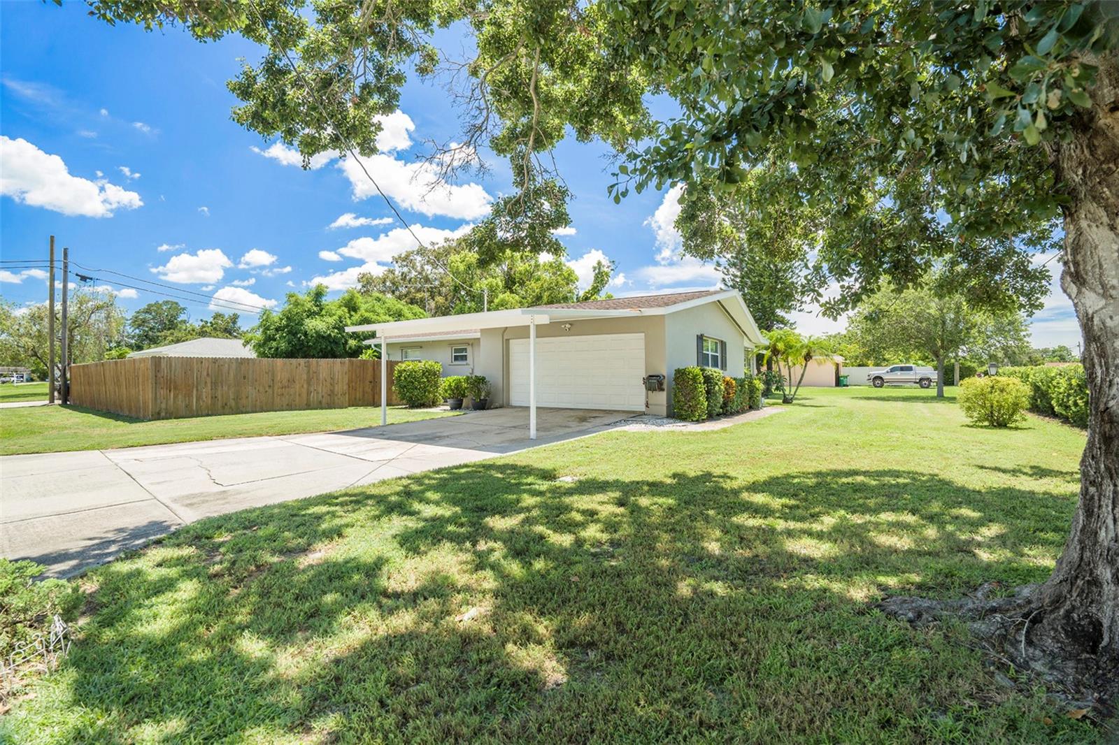 View of Carport, Garage, and fenced in side yard