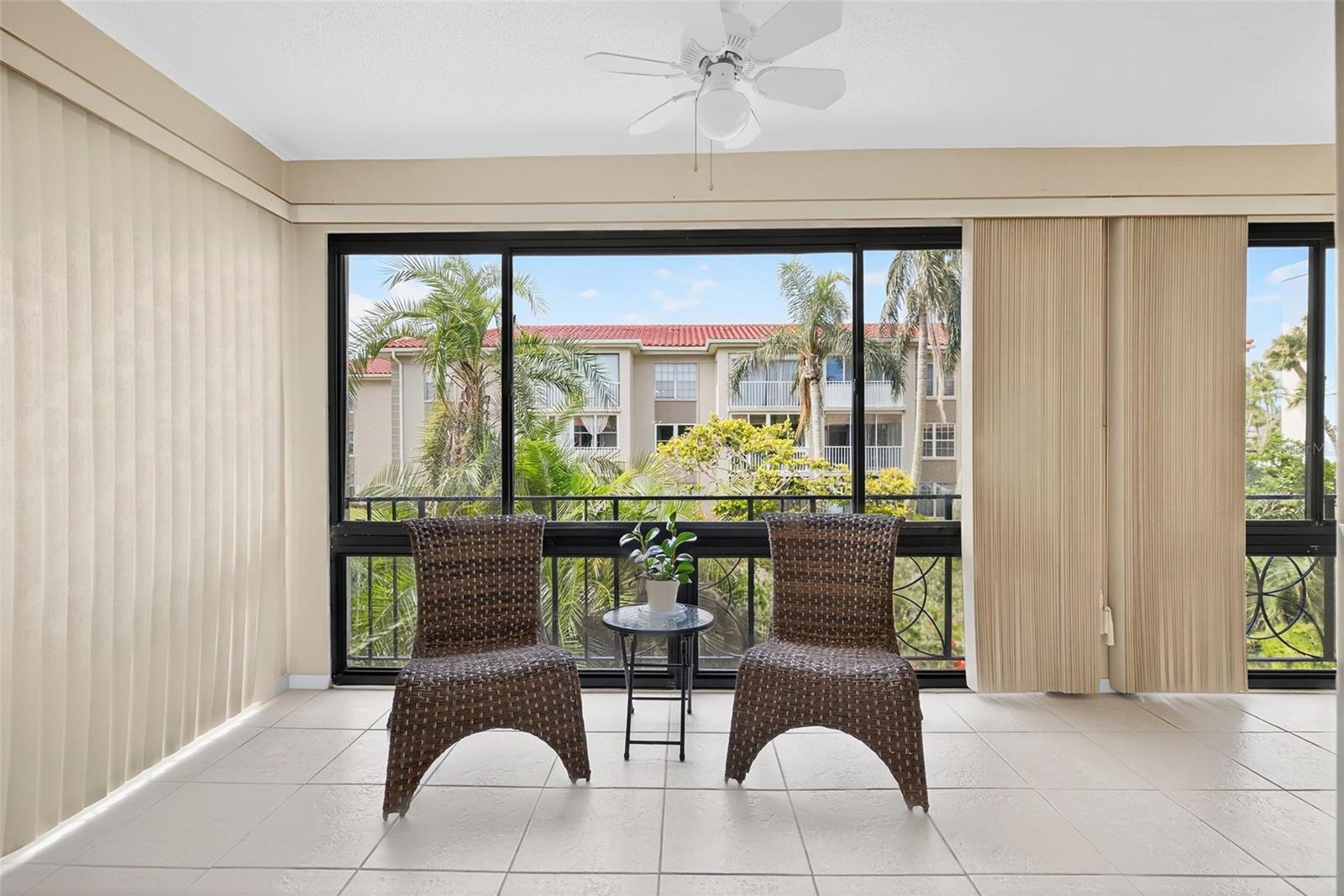 Glass Enclosed Patio with Ceiling Fans.    Open the windows in Spring/Fall/Winter to feel the fresh air.