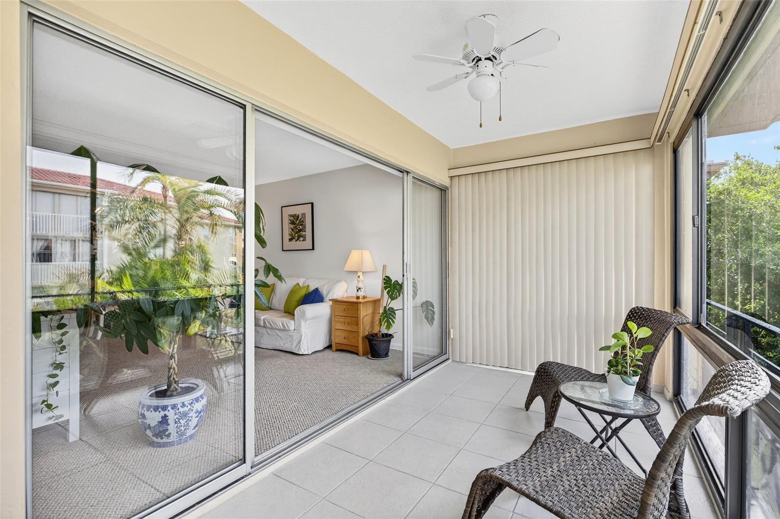 Glass Enclosed Patio with Ceiling Fans.    Open the windows in Spring/Fall/Winter to feel the fresh air.
