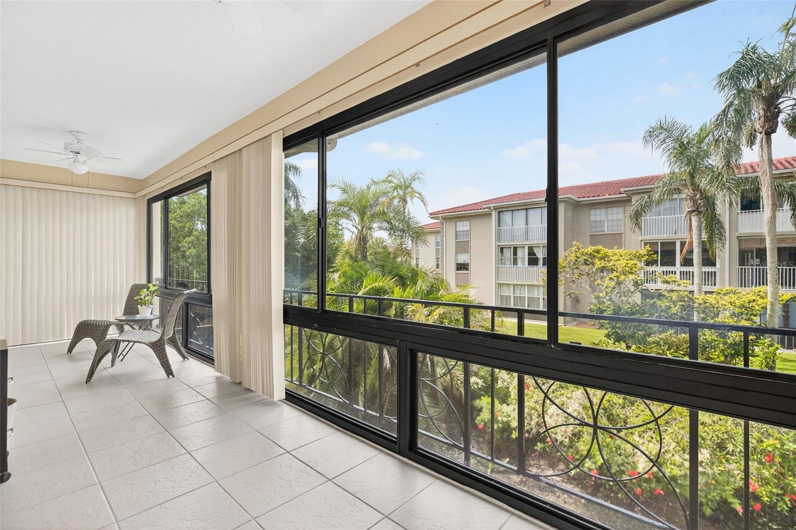 Huge Glass Enclosed Patio extends the entire length of the condo.  BONUS space to use as you see fit.