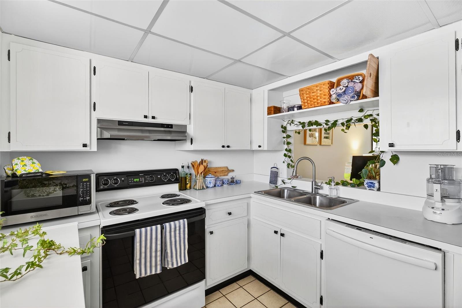 View from Kitchen to Living/Dining/Enclosed Patio areas.
