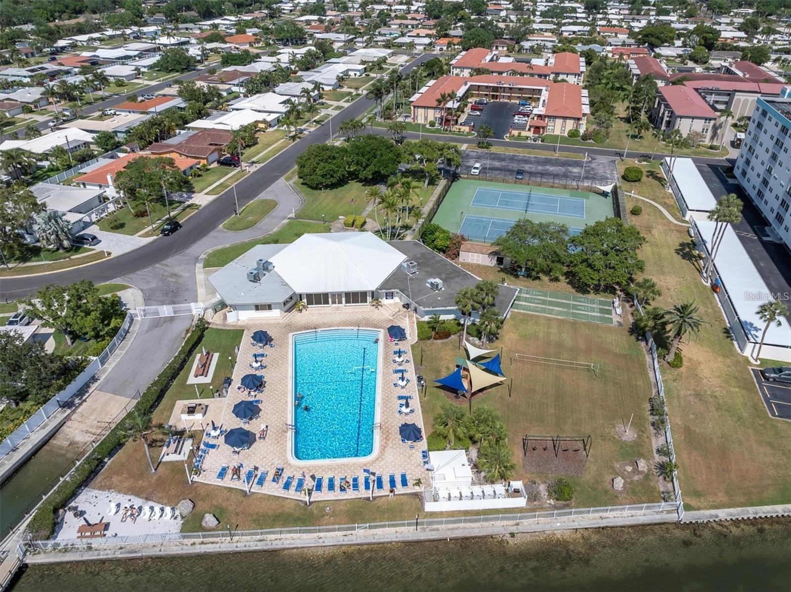 Aerial of Main Clubhouse, beach area to the left overlooking the Intracoastal and Sunsets.  In this picture, your condo is directly across the street.