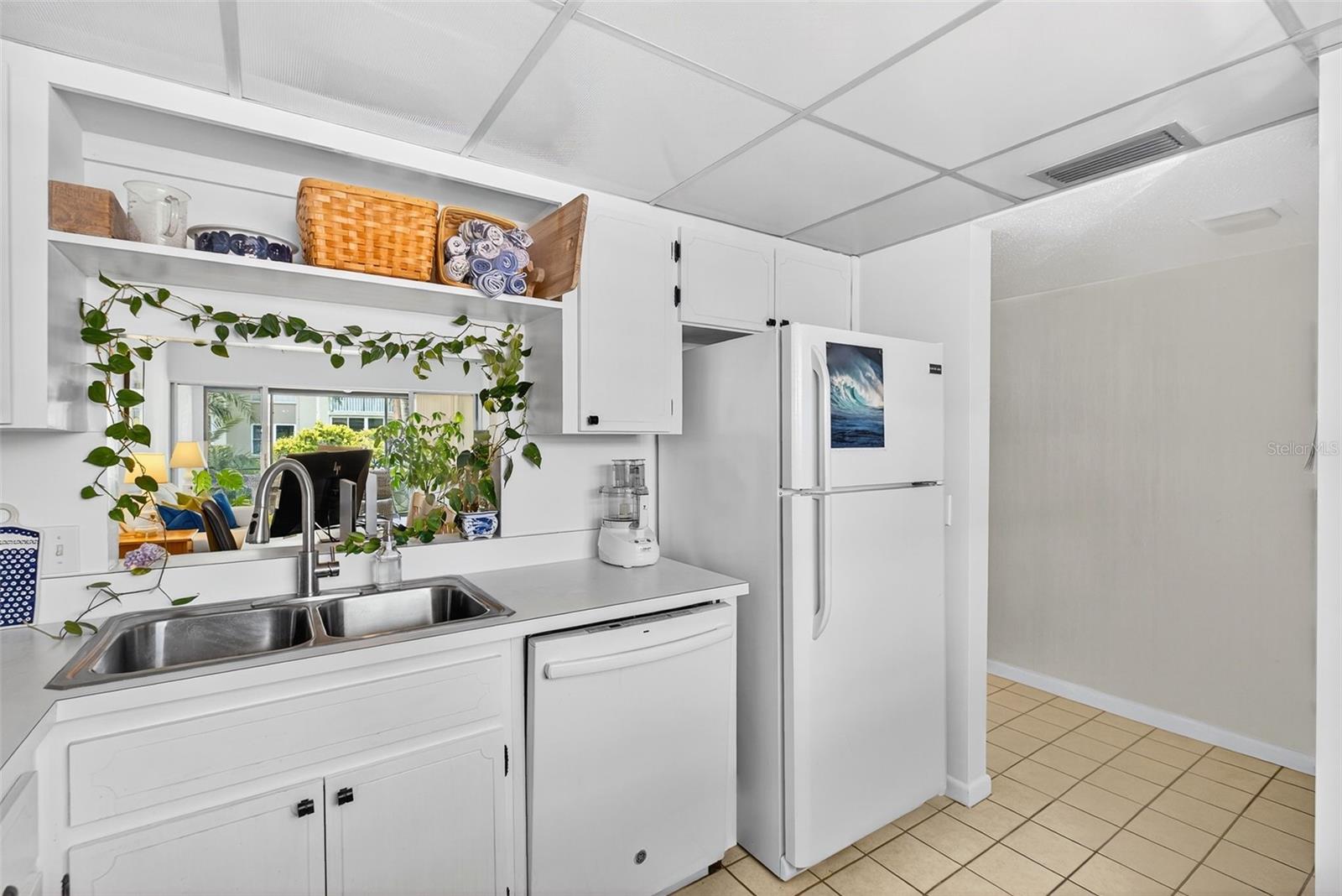View from Kitchen to Living/Dining/Enclosed Patio areas.