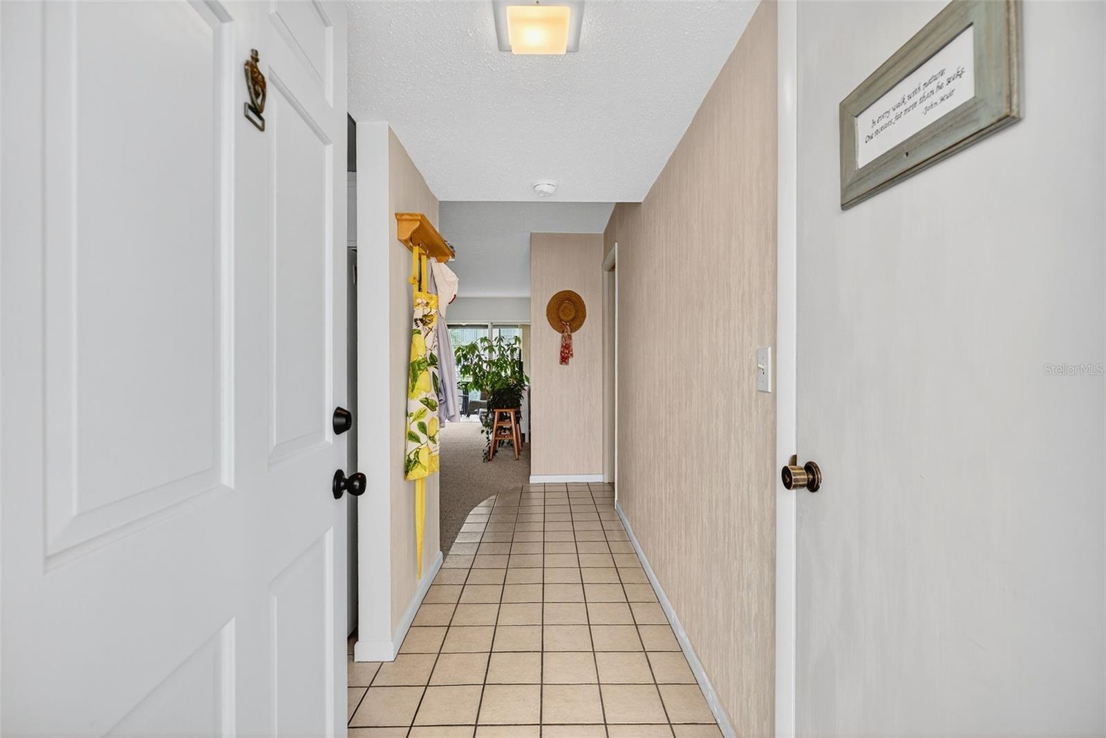 Storage Closet then Bedroom/Bathroom  & Enclosed Patio to the Right.  Kitchen, Living, Dining, Enclosed Patio to the Left.