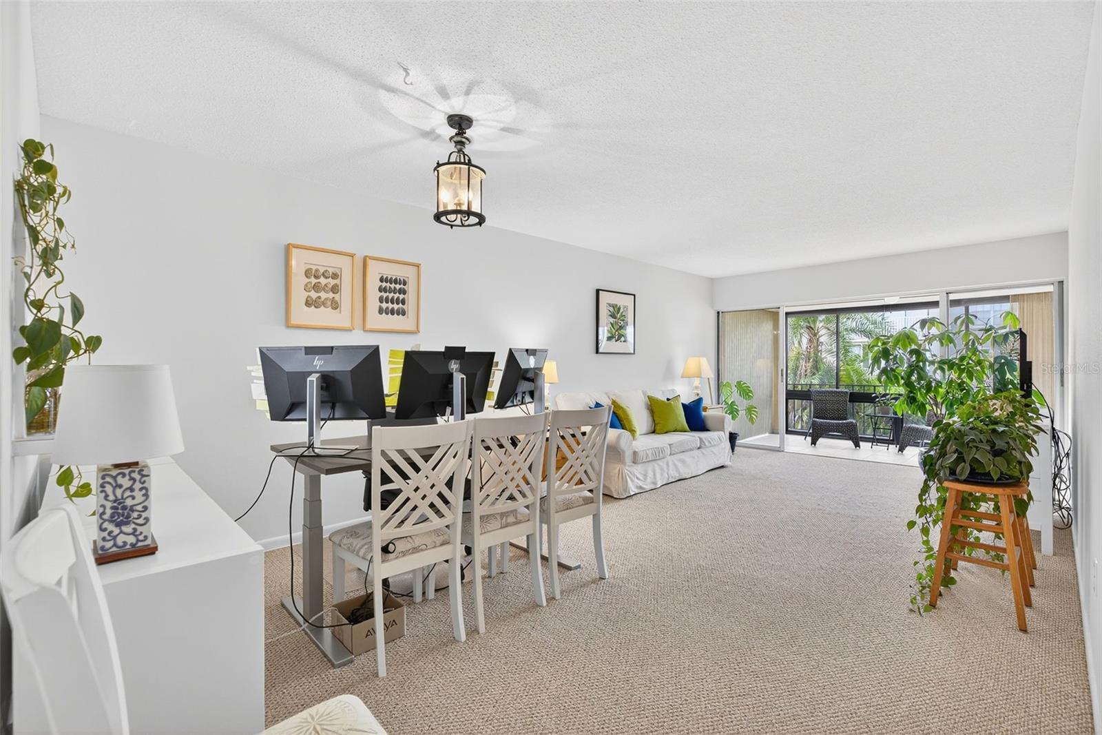 Dining & Living Room... Huge glassed in patio extends living area.