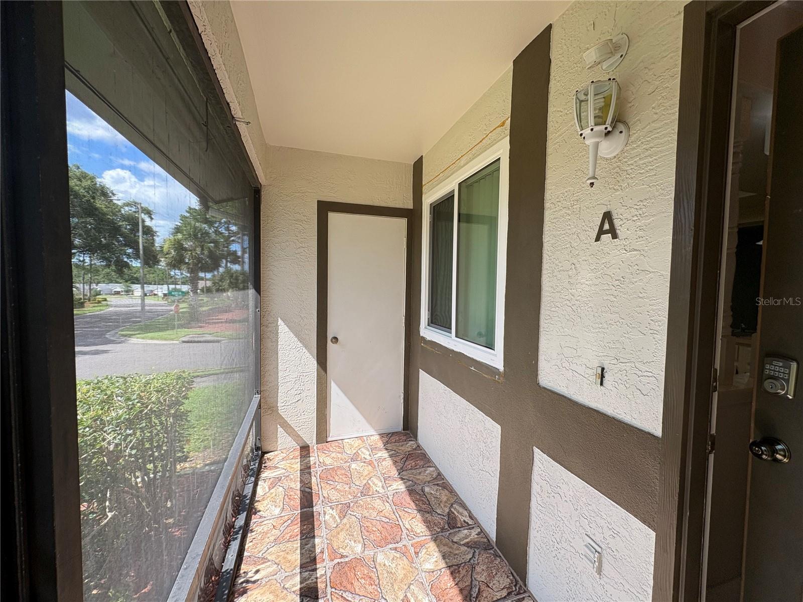 Front Entry Screened in porch with storage closet.