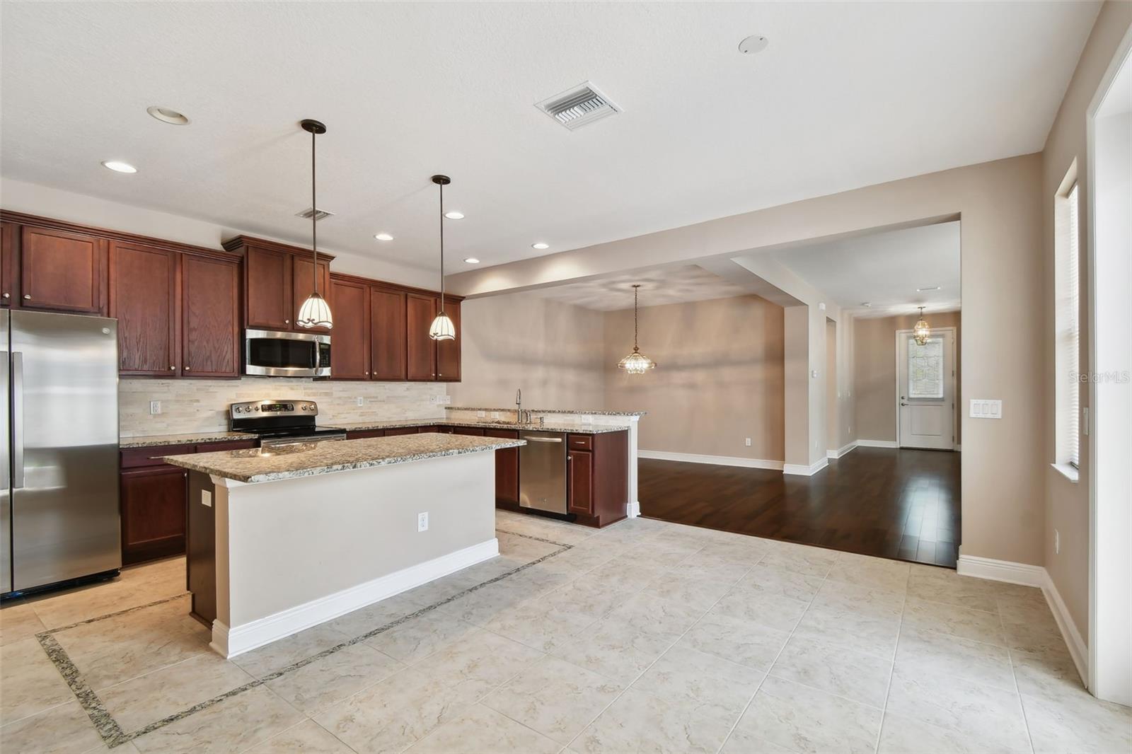 Kitchen looking at dining and foyer