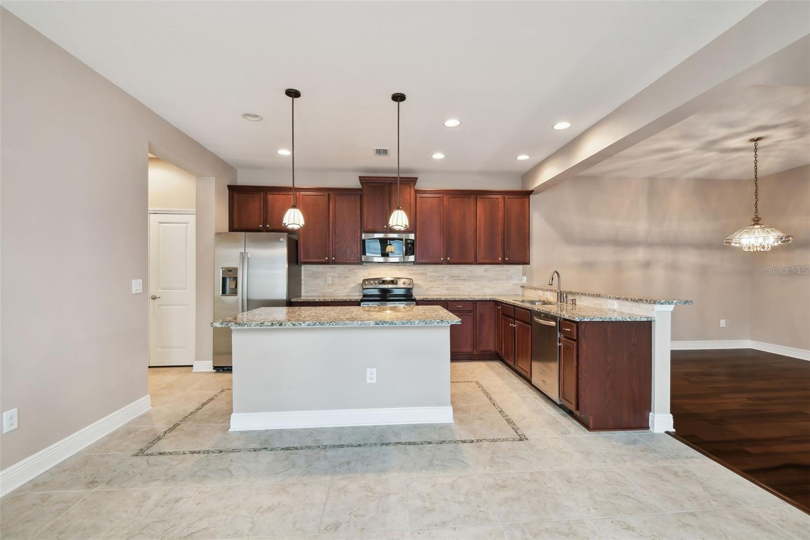 Kitchen offers island and owner added peninsula and