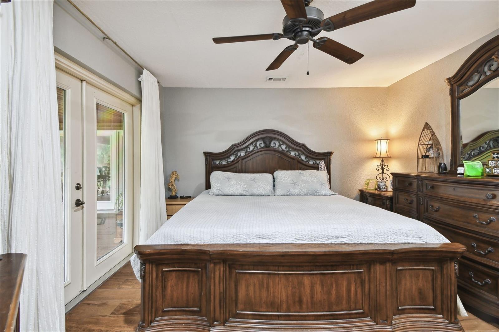 Master bedroom with french doors to the screened in lanai