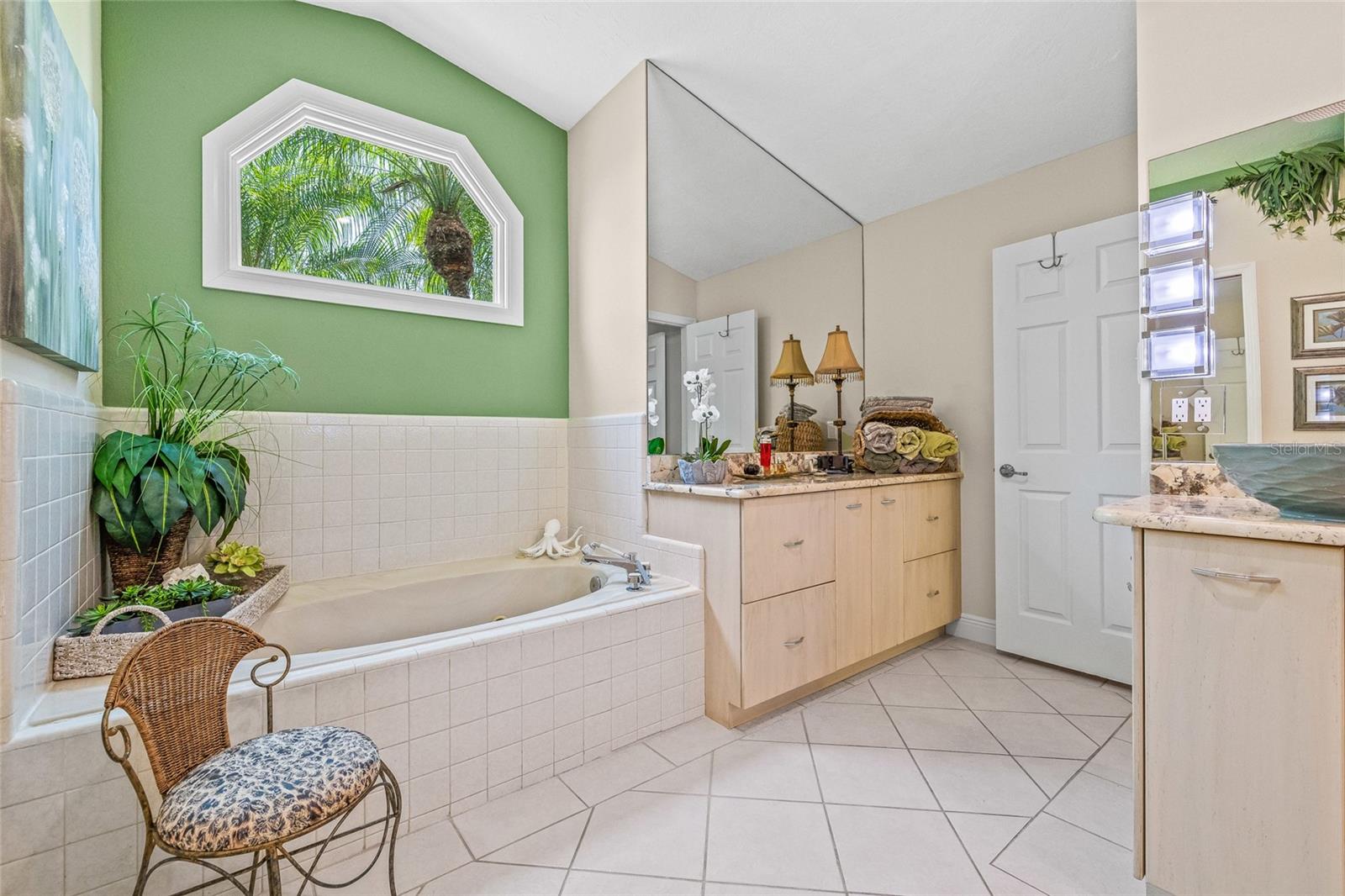Spa-like ensuite with a spacious tub and separate vanity area.