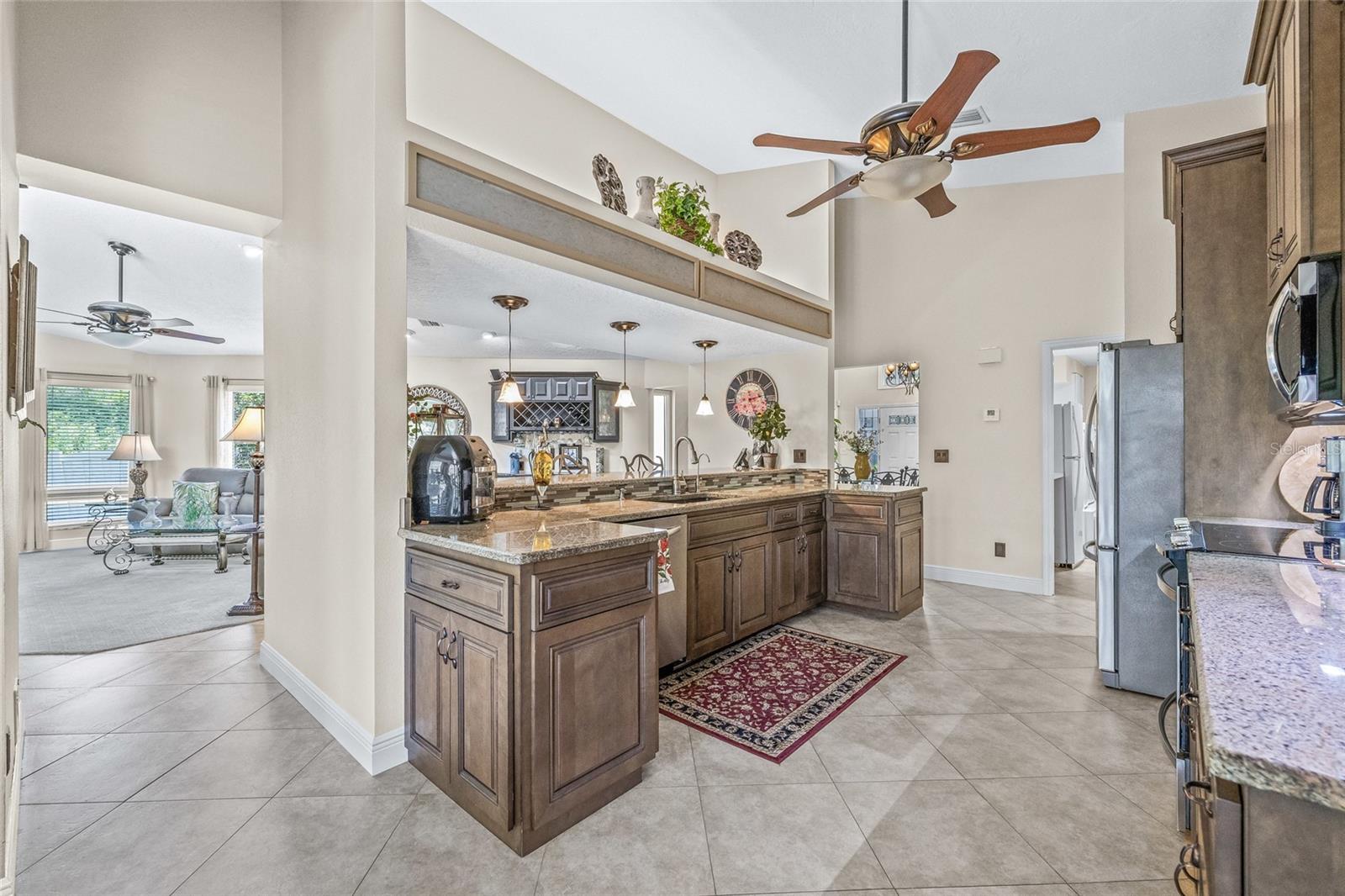 The kitchen’s breakfast bar overlooks the family room, creating the perfect setting for gathering and conversation.