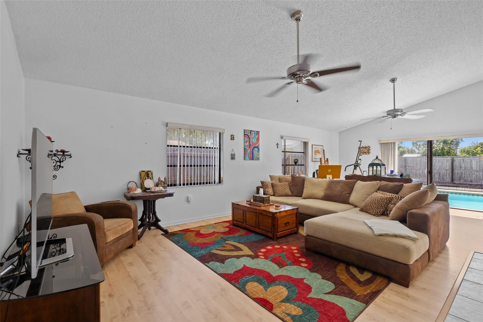 The open concept design combines the kitchen, dinette, and living room