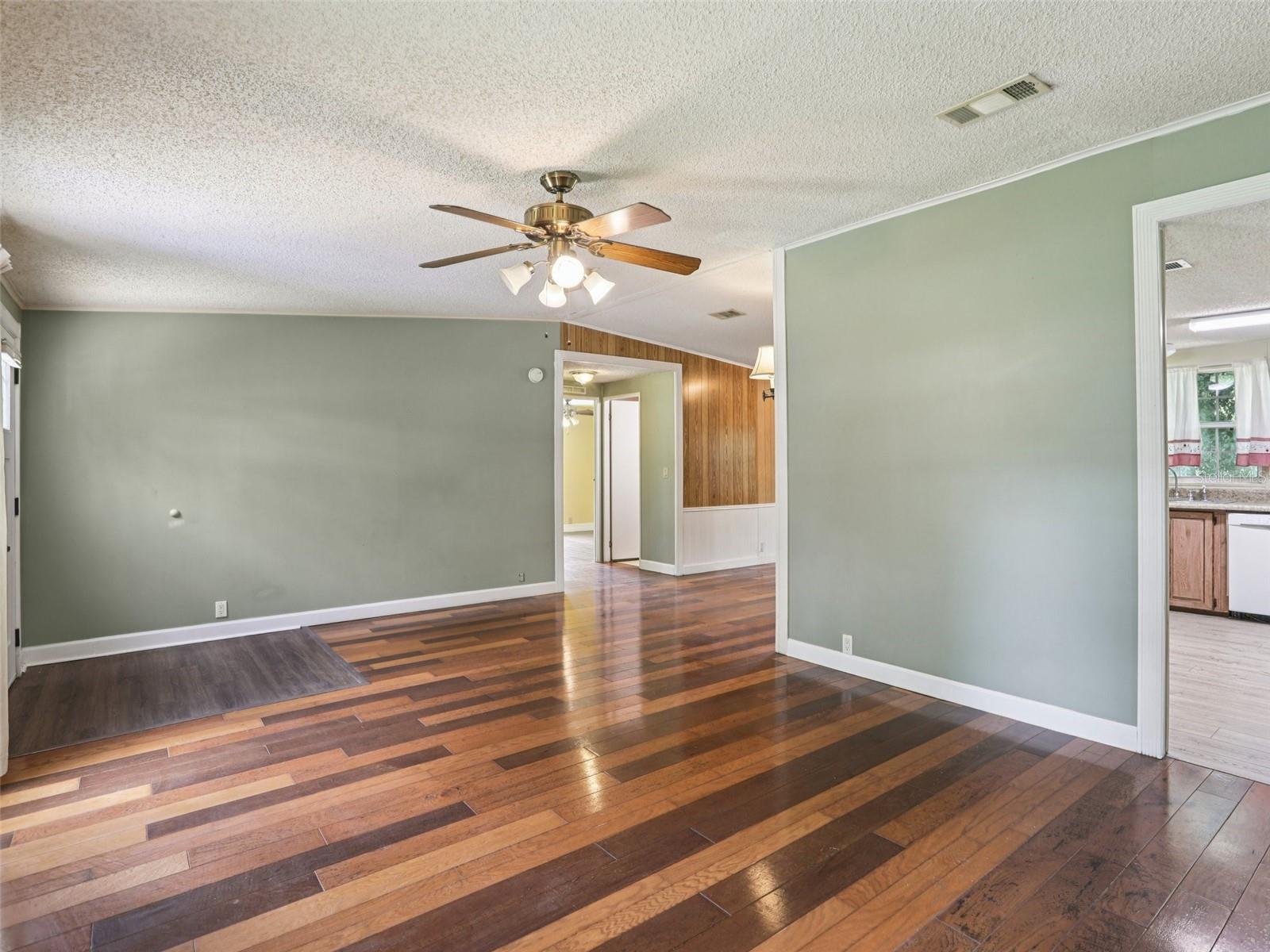 Living room facing hallway and 2 additional bedrooms