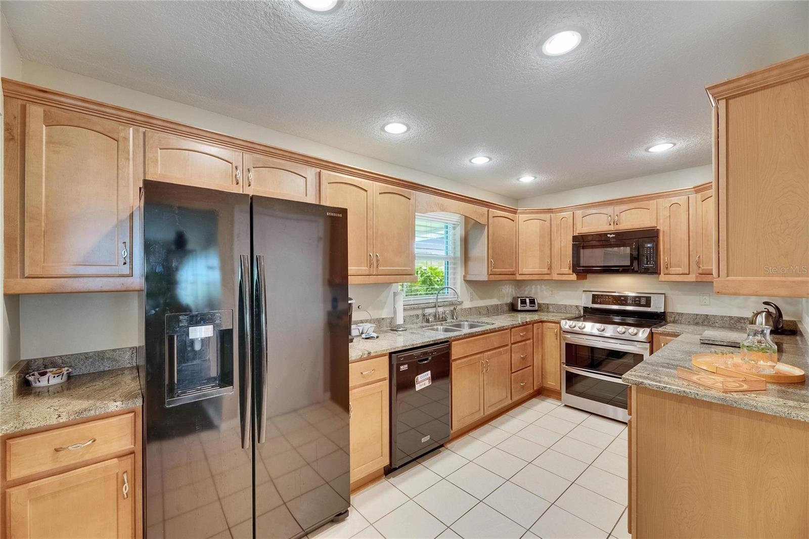 Maple cabinets have molding along the top and bottom.  Granite countertops.