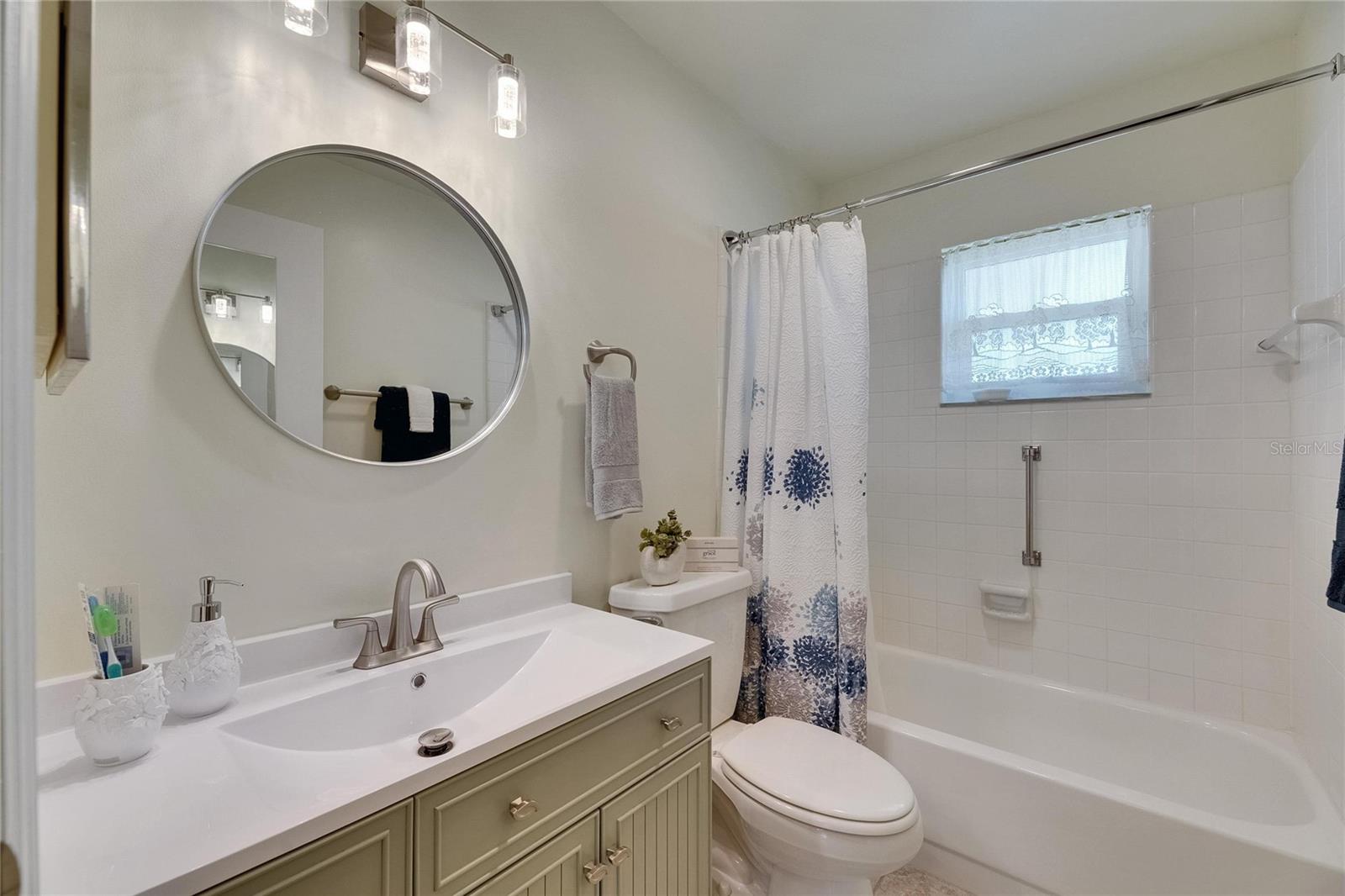 Guest bathroom has a new tall vanity, mirror and light