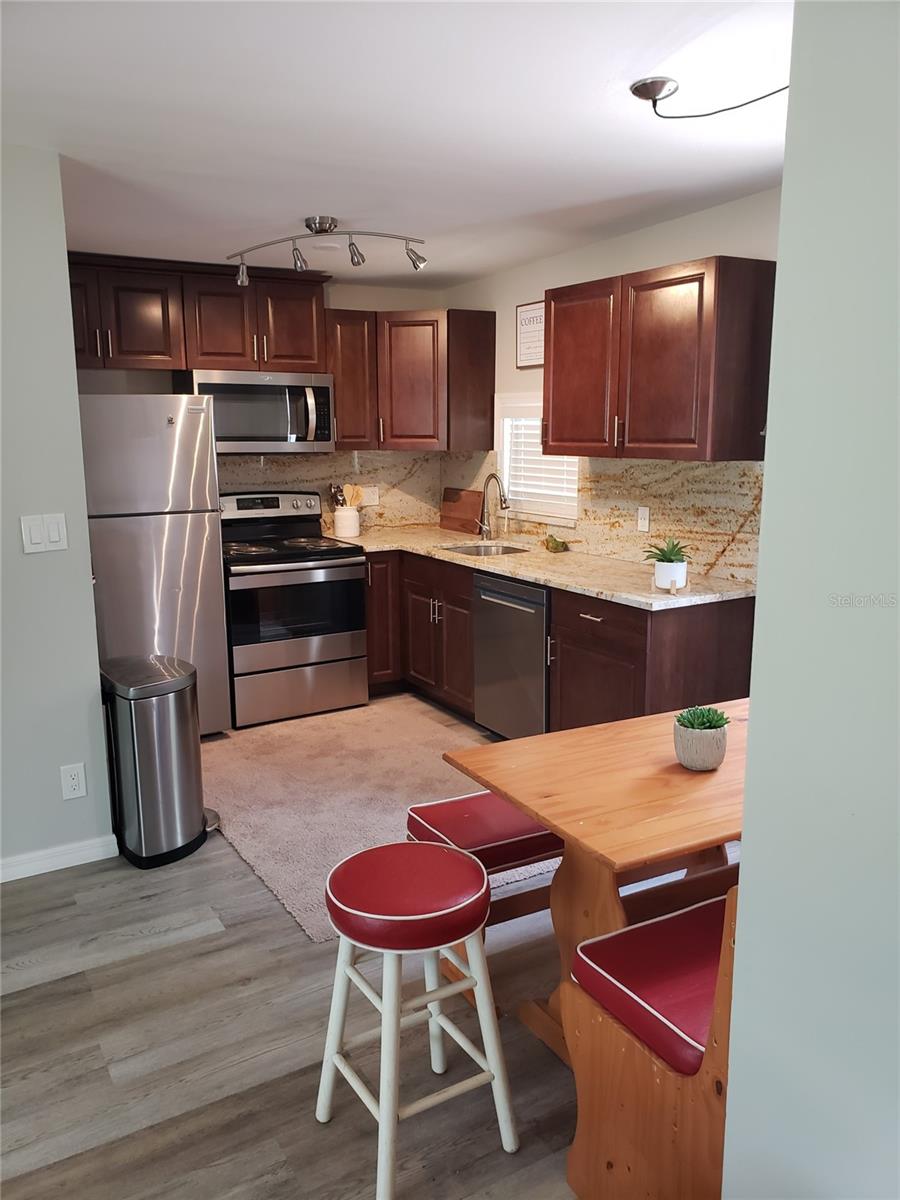 Kitchen with water resident laminate flooring throughout the house.