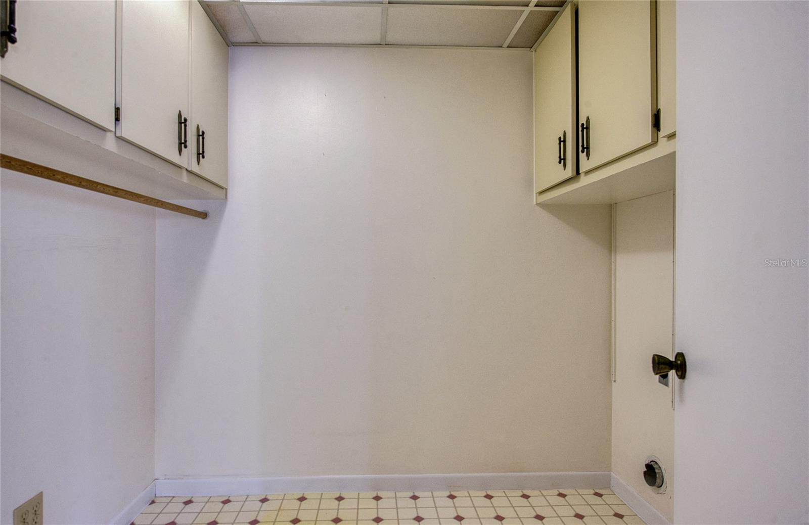 INSIDE LAUNDRY ROOM WITH CABINETRY