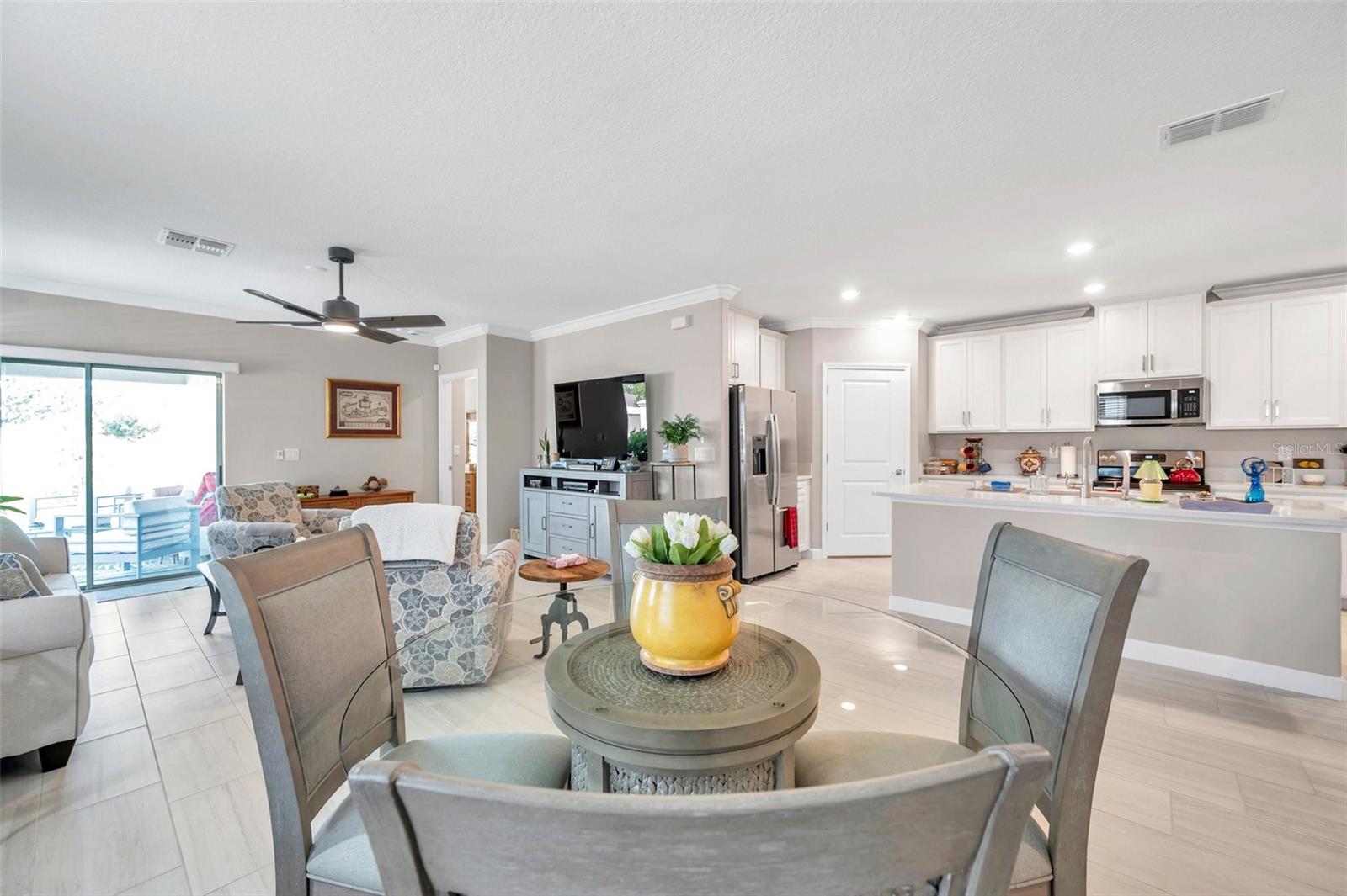 Showing the open floor plan - View from the dining room to the living room, covered patio and large kitchen