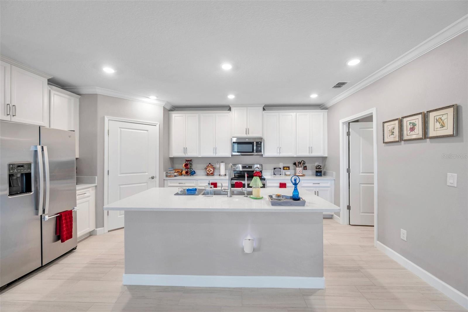 Kitchen with center island, stainless steel appliances, walk-in closet