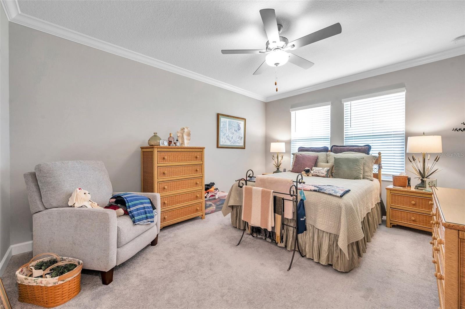 Primary bedroom with plenty of room and crown molding