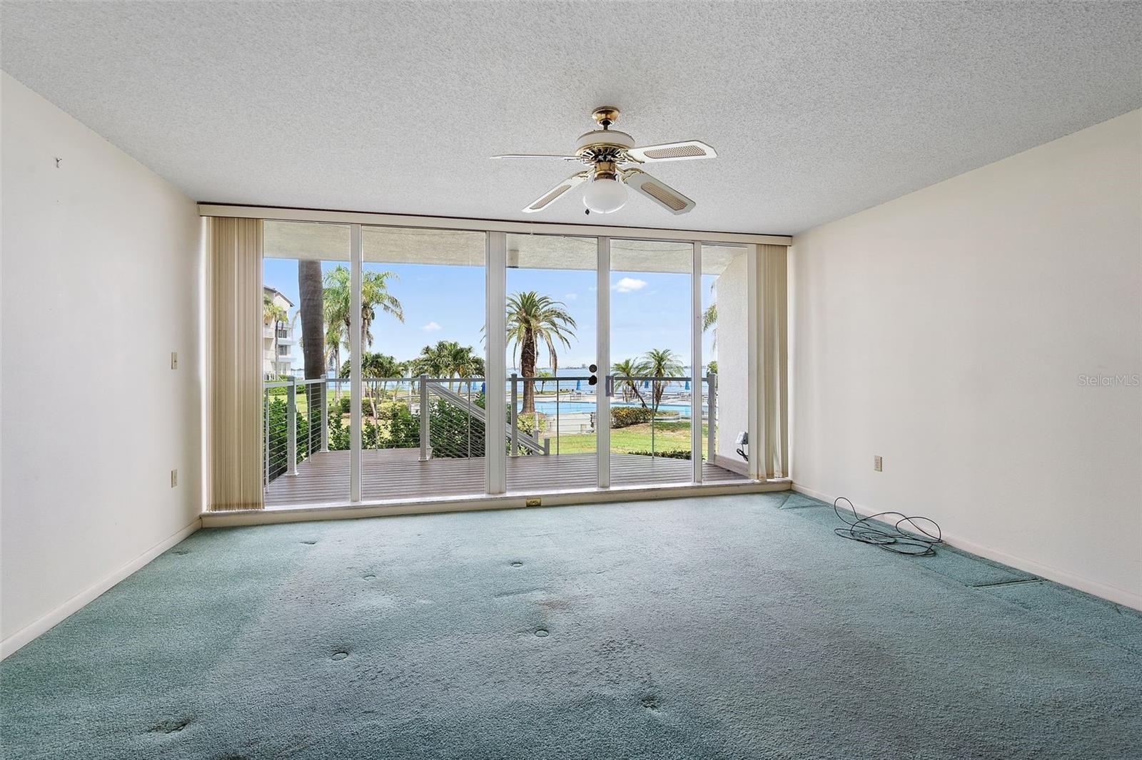 Living room with amazing views of Bocca Ciega Bay and pool