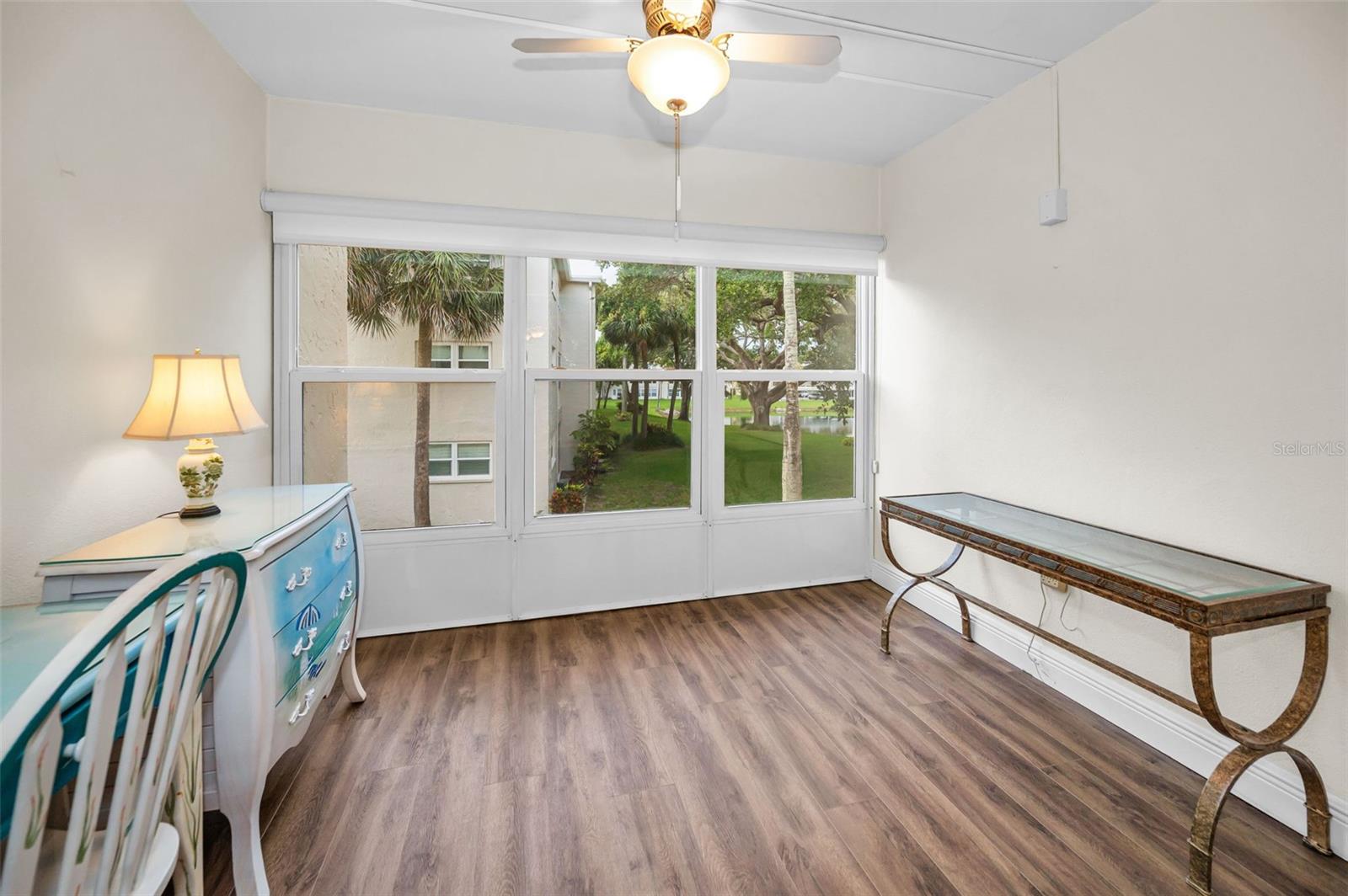 Enclosed balcony with newer windows and a view of the lake.