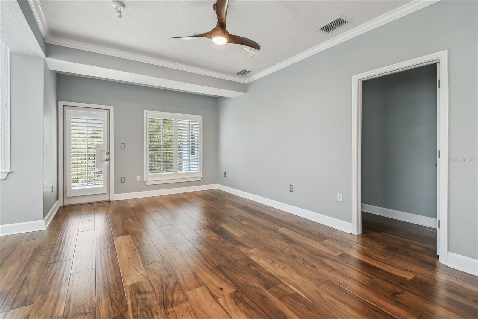 Living room with door leading to over-sized balcony.